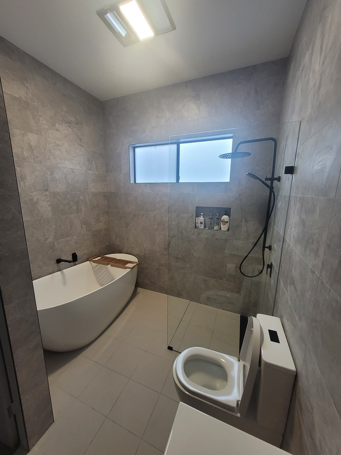 Grey bathroom with freestanding bath and walk-in shower