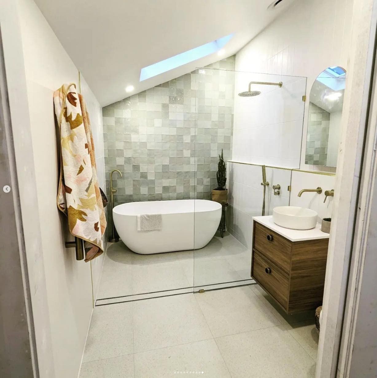 Mayfield bathroom — tile feature wall and gold fixtures