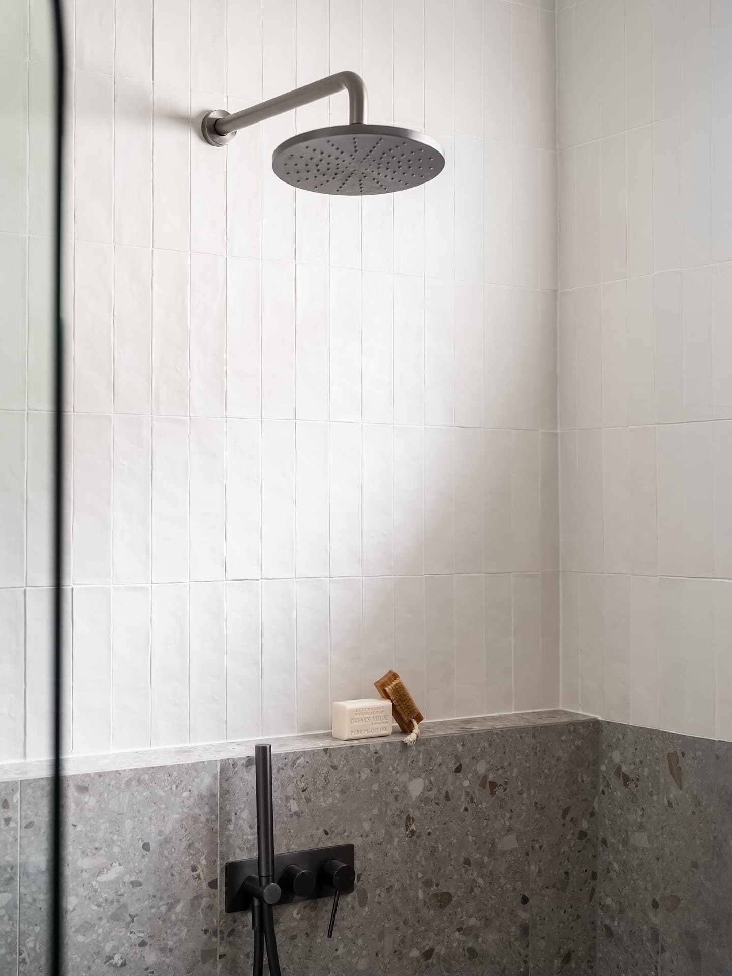 Walk-in shower with brushed brass rain head