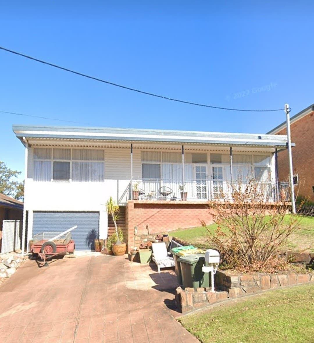 Before — the original brick house from the street