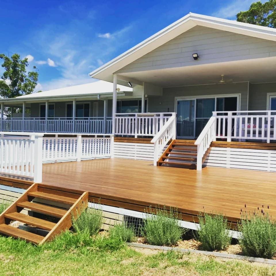 The finished deck with the stairs down to the lawn