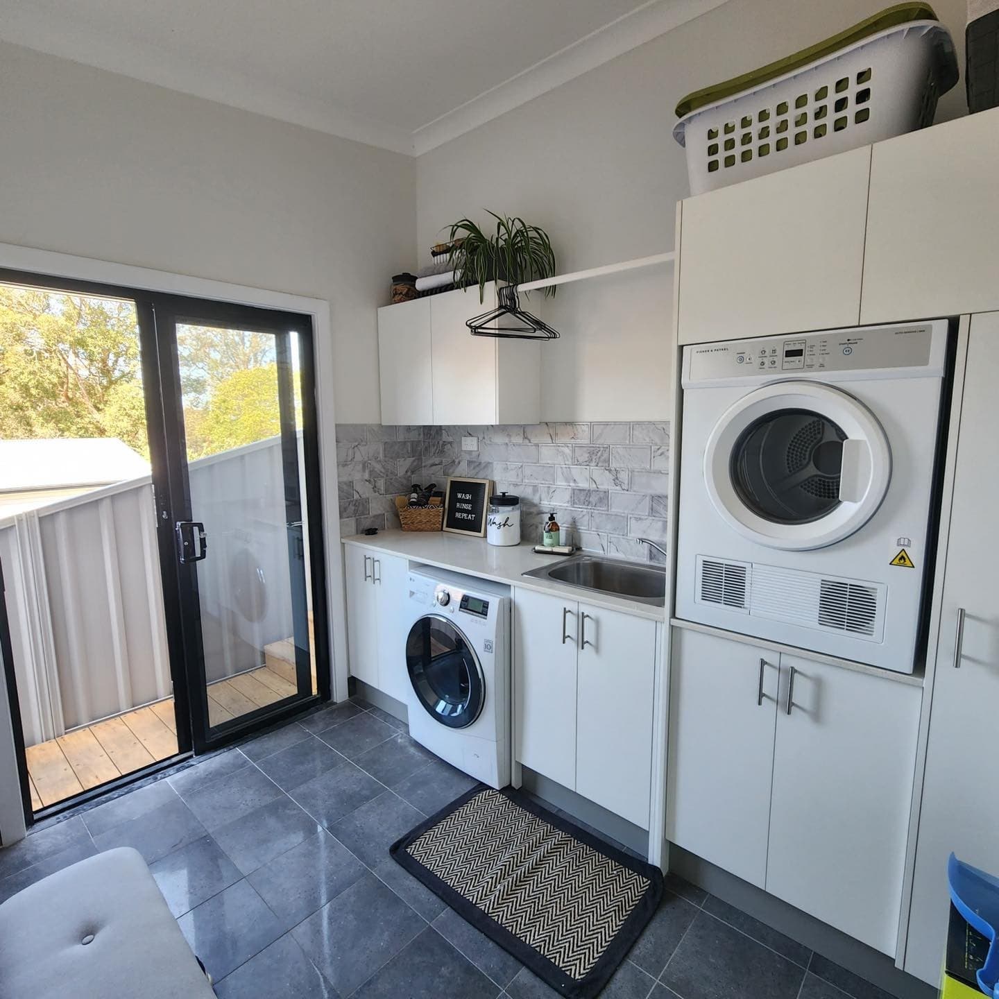 Laundry with storage and a door to the yard