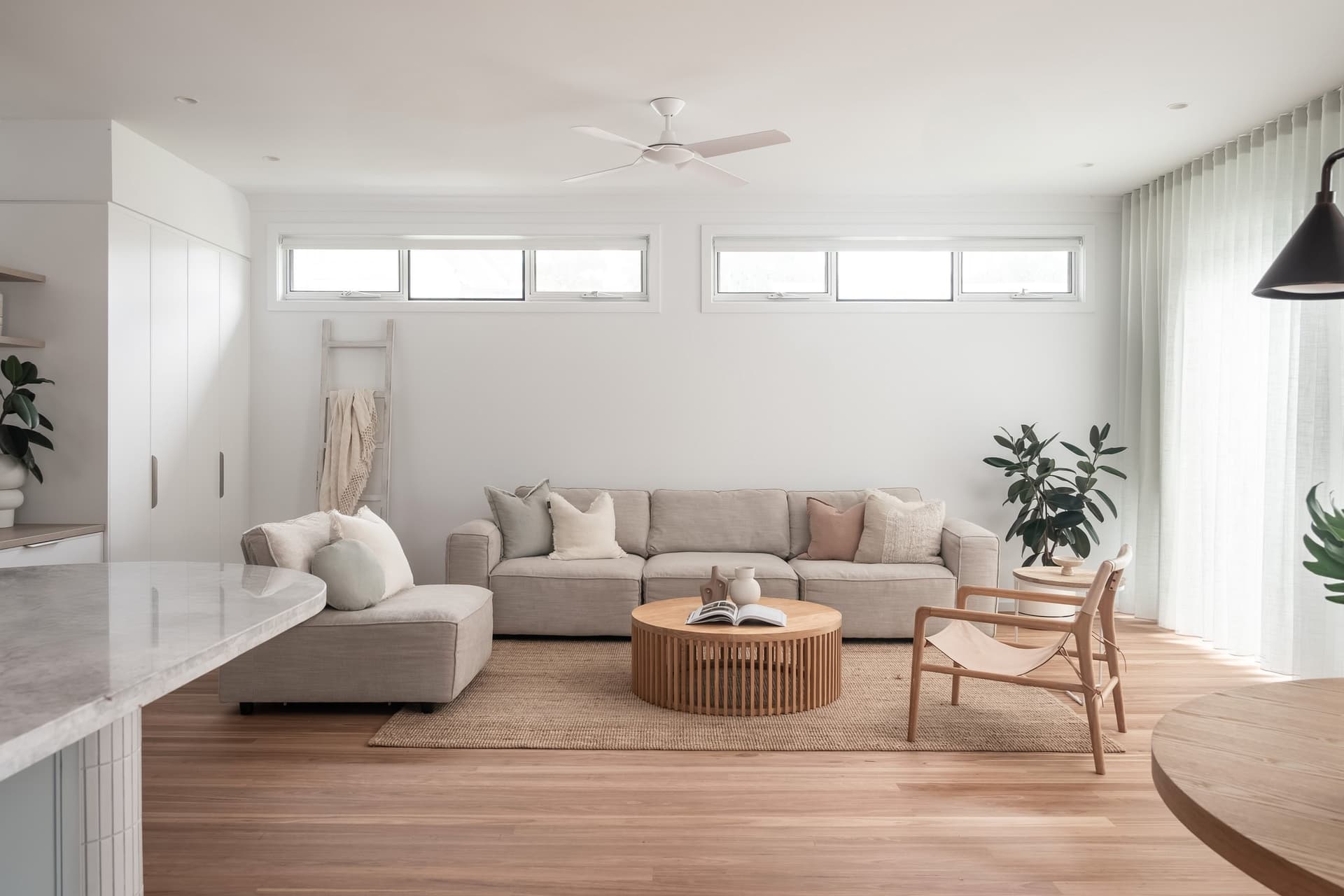 Living room with sheer curtains and timber floors