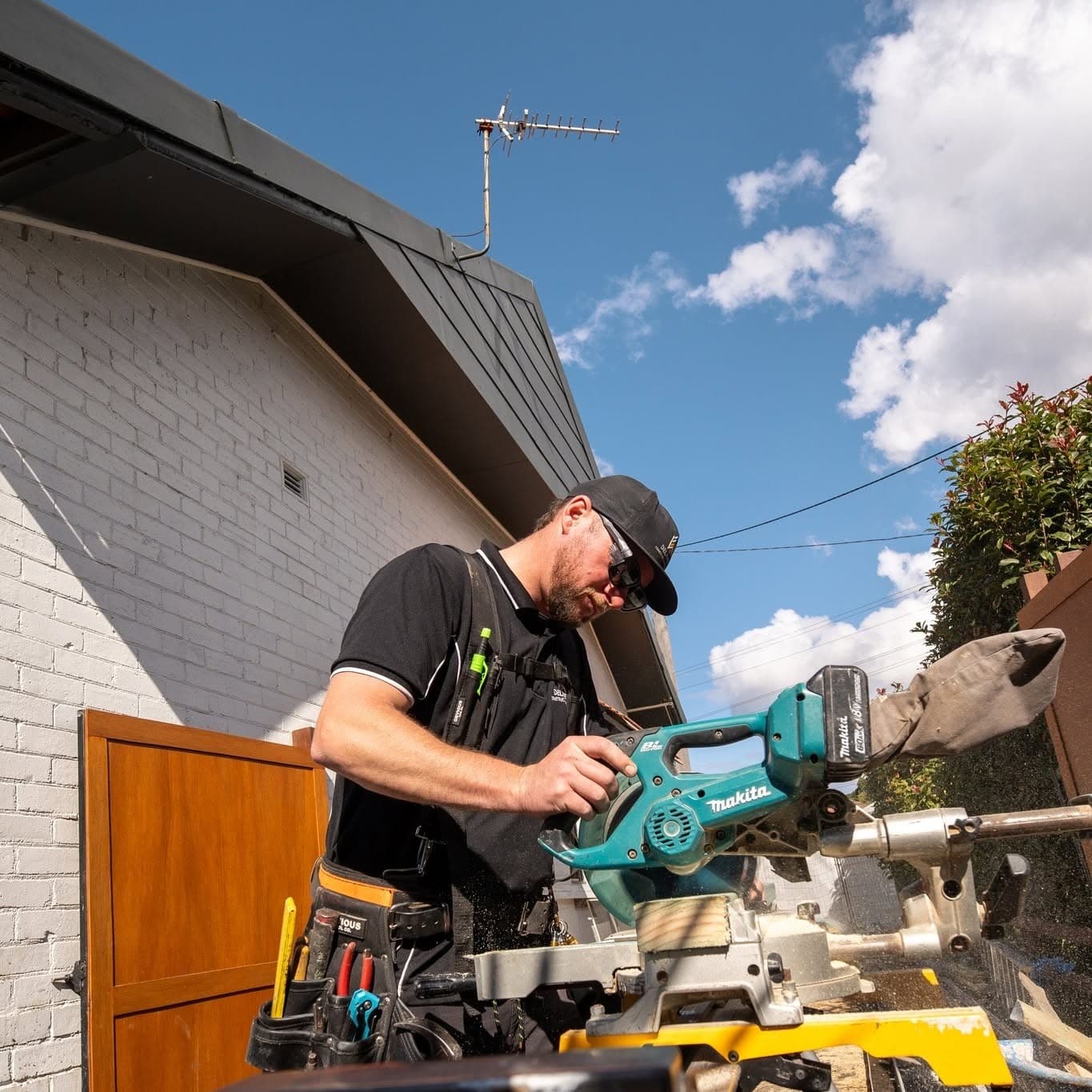 Cutting on the drop saw on a Delaney Construction Projects site